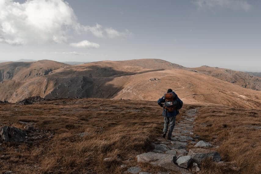 Man walking along the trail away from the camera in Kosciuszko National Park, NSW