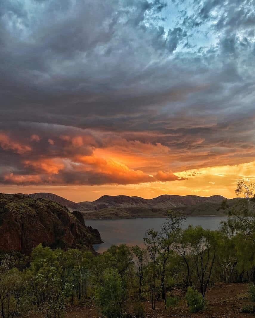 Sunset over the water surrounded by green trees in the Kimberley Austrlia