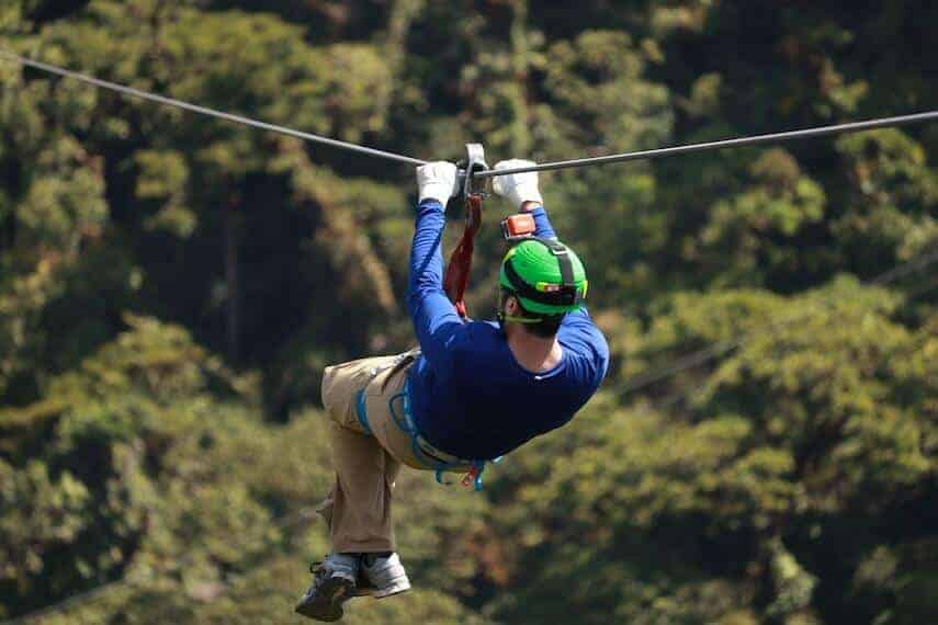 Man ziplining in the forest