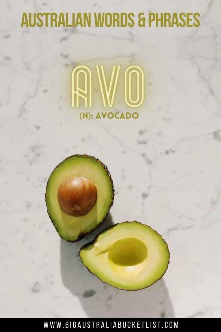 Australian Slang Words - Avo = Avocado (featuring an avocado open in halfs on a marble bench top with text overlay of the translation