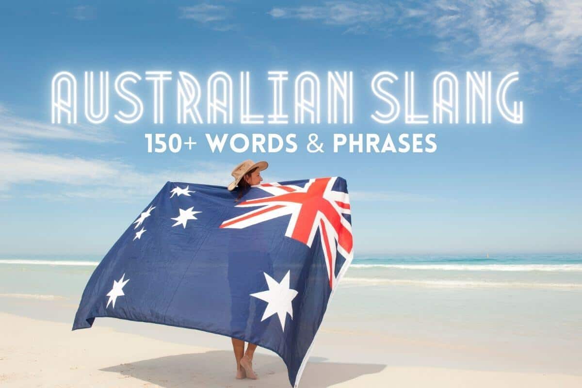 150+ Australian Slang Words & Phrases header image of a woman holding an Australian flag outstretched behind her on the beach wearing a stetson