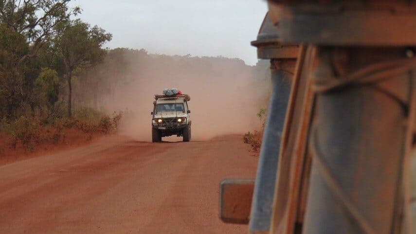 4x4 driving towards the camera on a dusty red road in the Australian outback