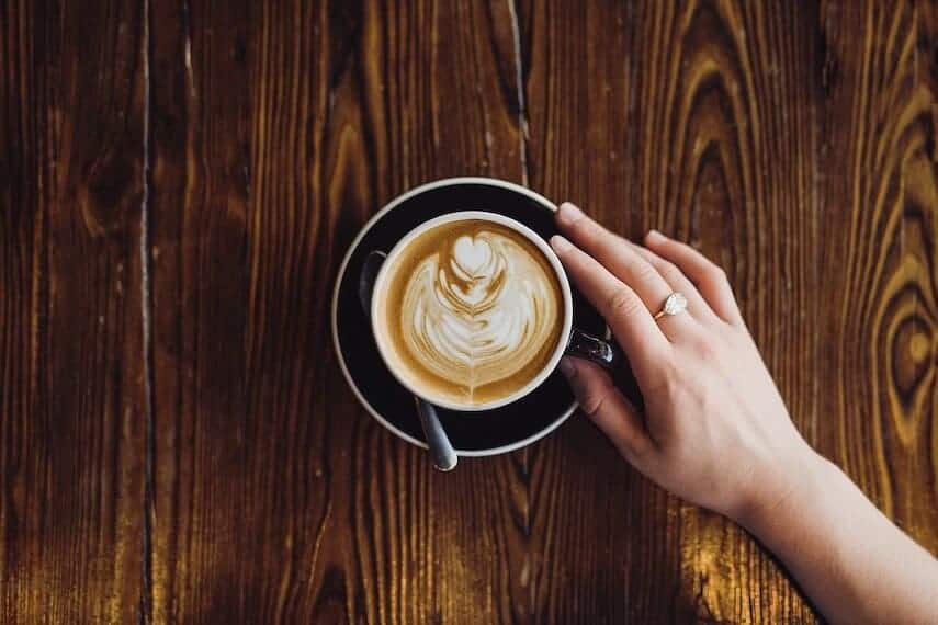 Flat White Coffee on Dark Wooden Table