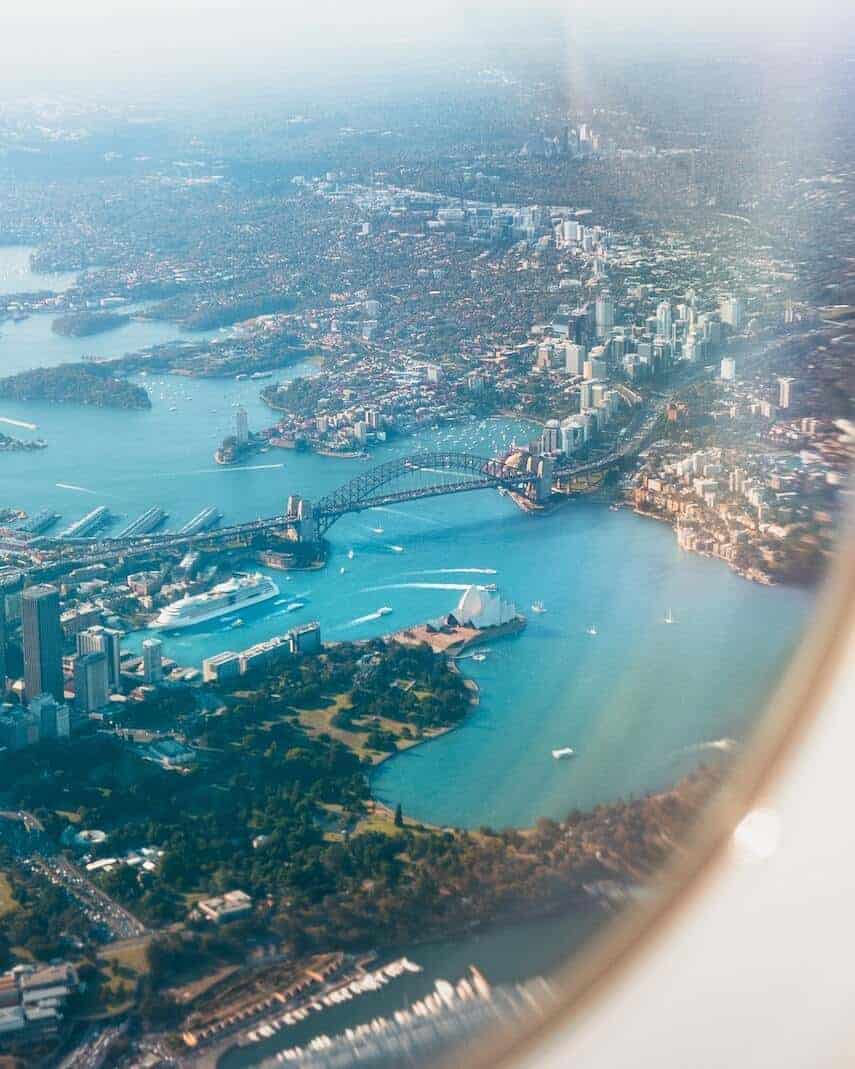 Sydney harbour out of the round window of an airplane