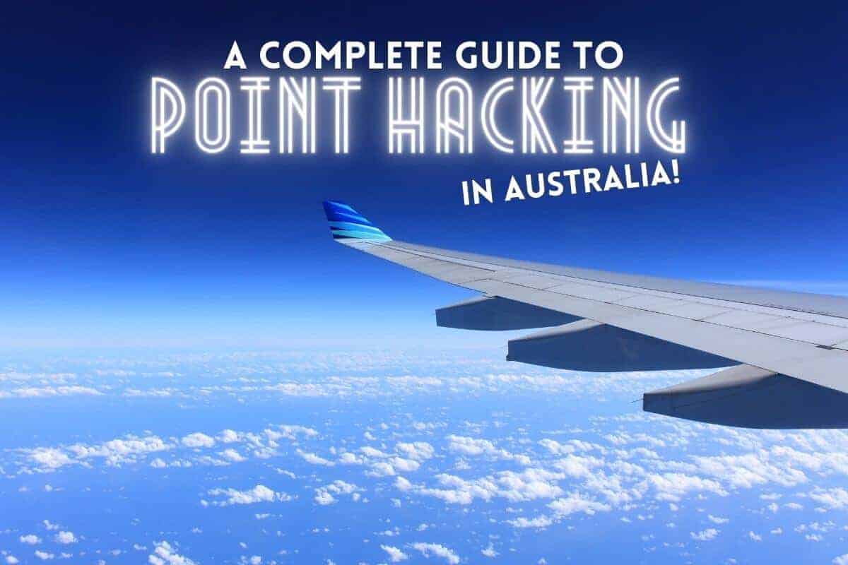 Guide to Point Hacks for Australia cover photo of the wing of an airplane flying above white clouds under a blue sky