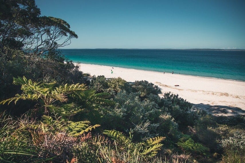 Jervis Bay white sand beach, aqua green ocean and lush green landscape