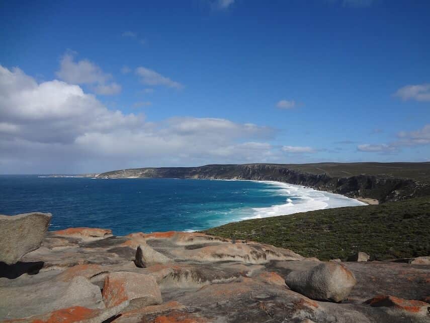 Curved coastline of Kangaroo Island with white sand at the edge of the azure blue ocean