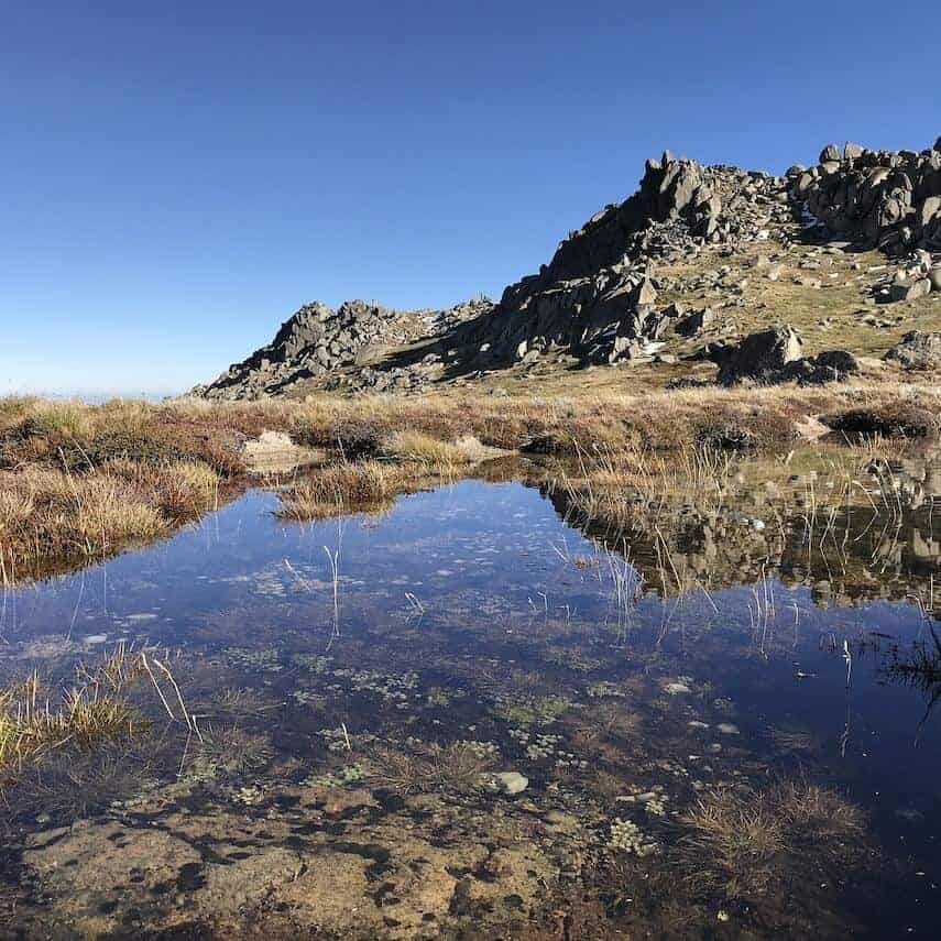 Rocky outcrop reflected in a shallow pool of water below in Kosciuszko National Park