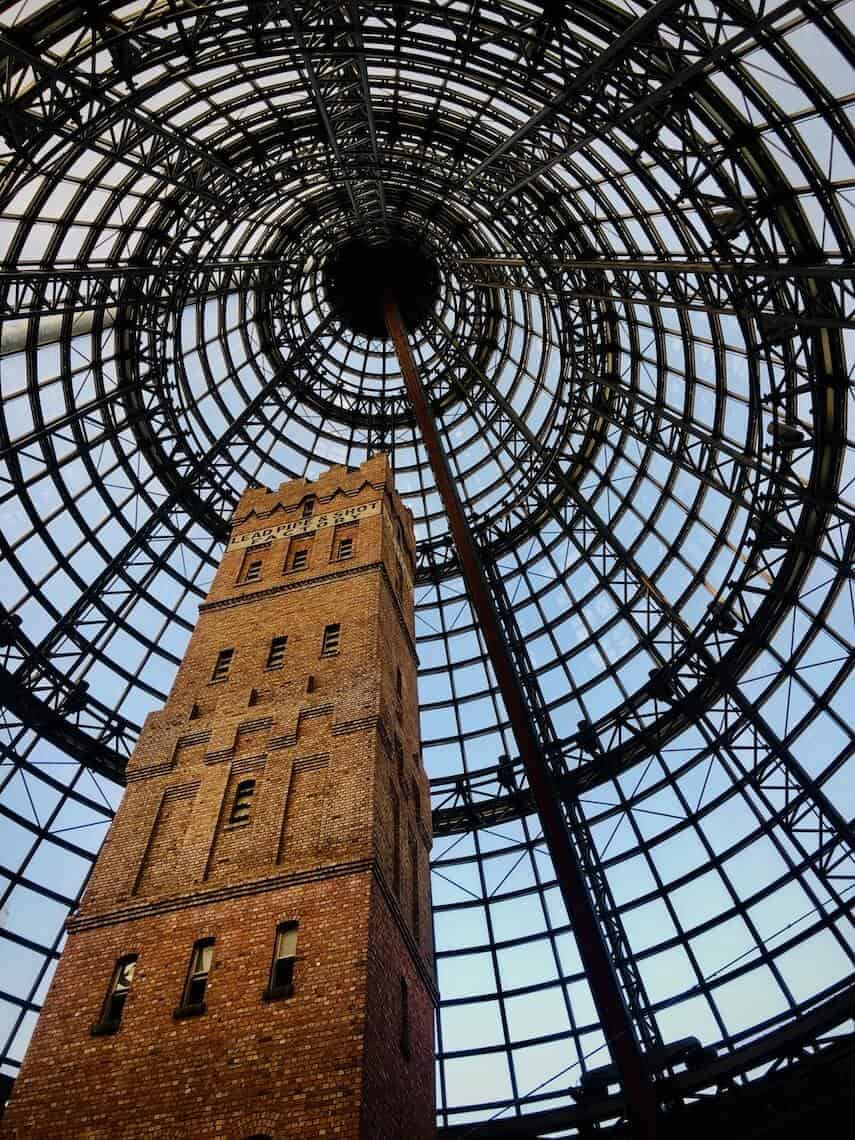 Looking up towards the shot tower buisling and accompanying metal and glass dome that surrounds it