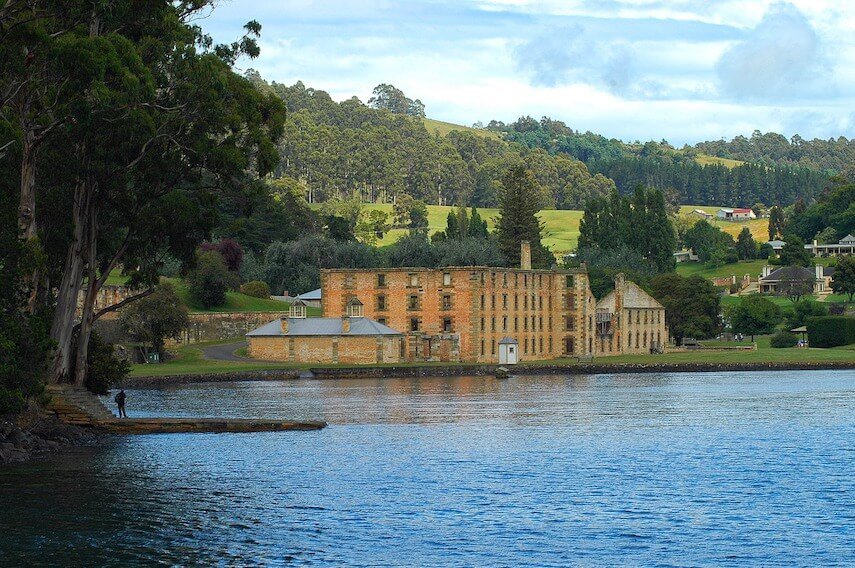 Port Arthur Prison Building across the lake with green fields in the background