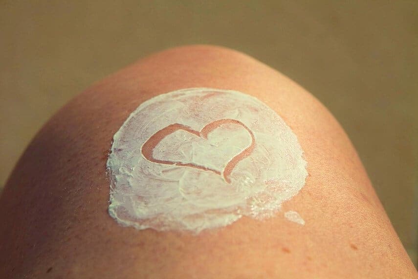 Knee with a circle of sunscreen with a heart drawn into it
