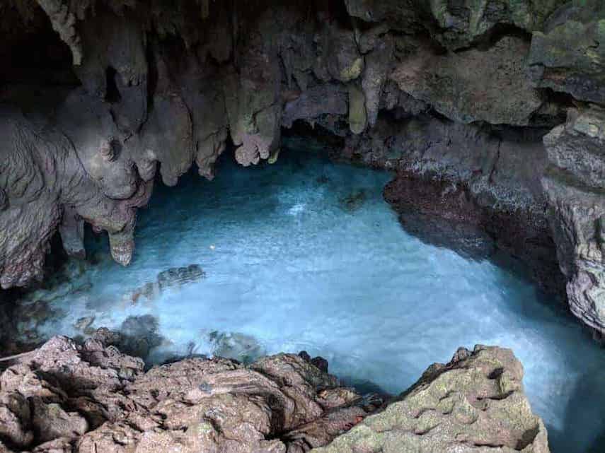 Rocky cavern with a clear blue sand bottomed natural pool at it's centre at The Grotto on Christmas Island