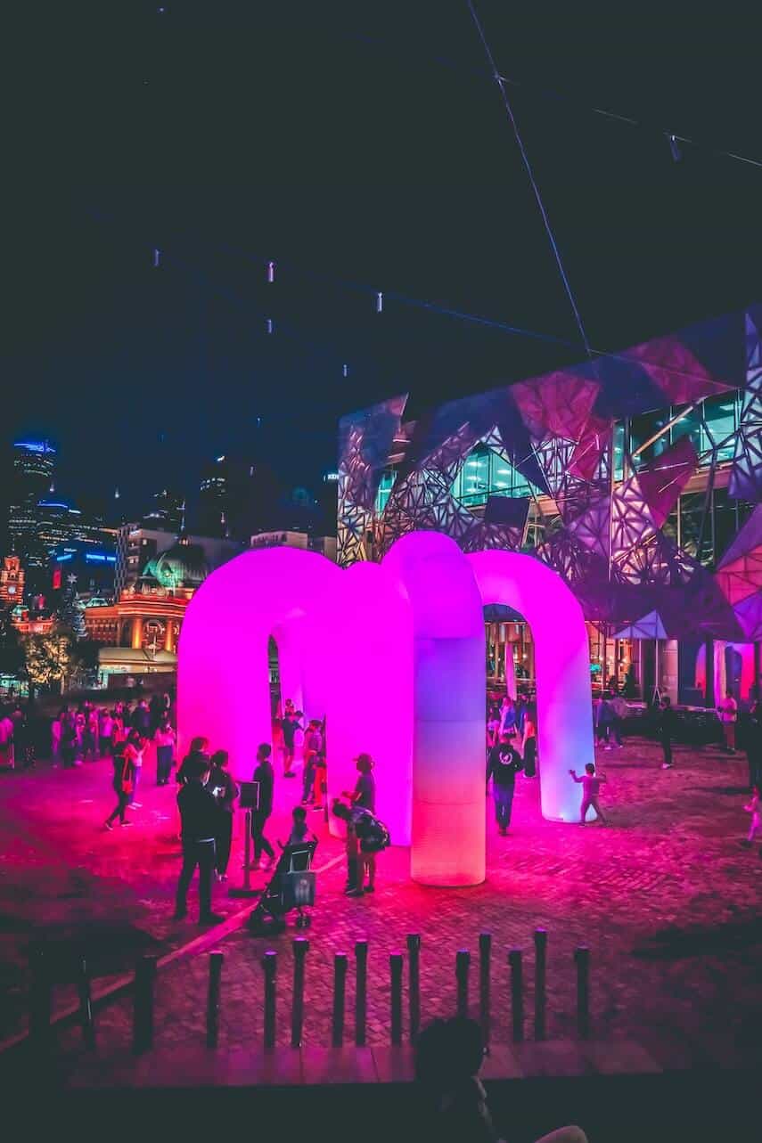 Illuminated structure bathed in pink light in Fed Square in Melbournes CBD