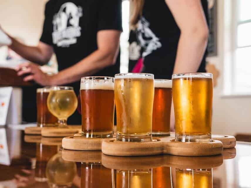 4 Craft beers of different colours on a wooden paddle