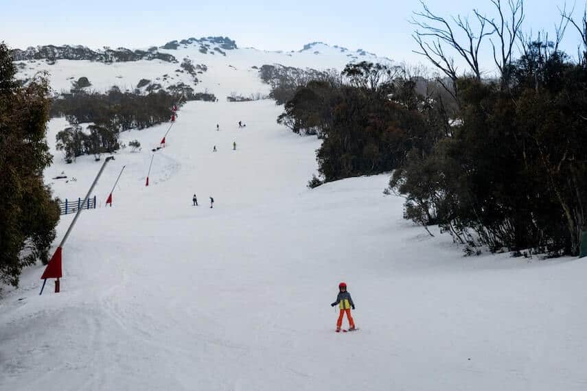Thredbo Ski Resort NSW view up a ski slope looking towards to top of the mountain and snow cannons line the ski run