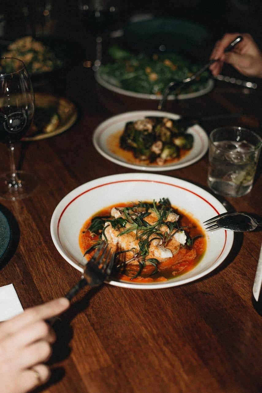 Several different food dishes on a wooden table