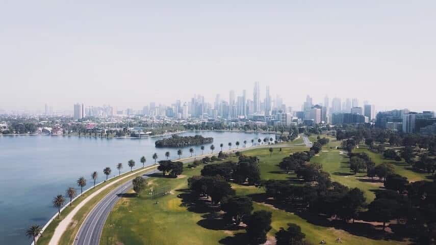 Aerial shot of Melbourne from Albert Park with Port Phillip Bay on the left and the city in the background