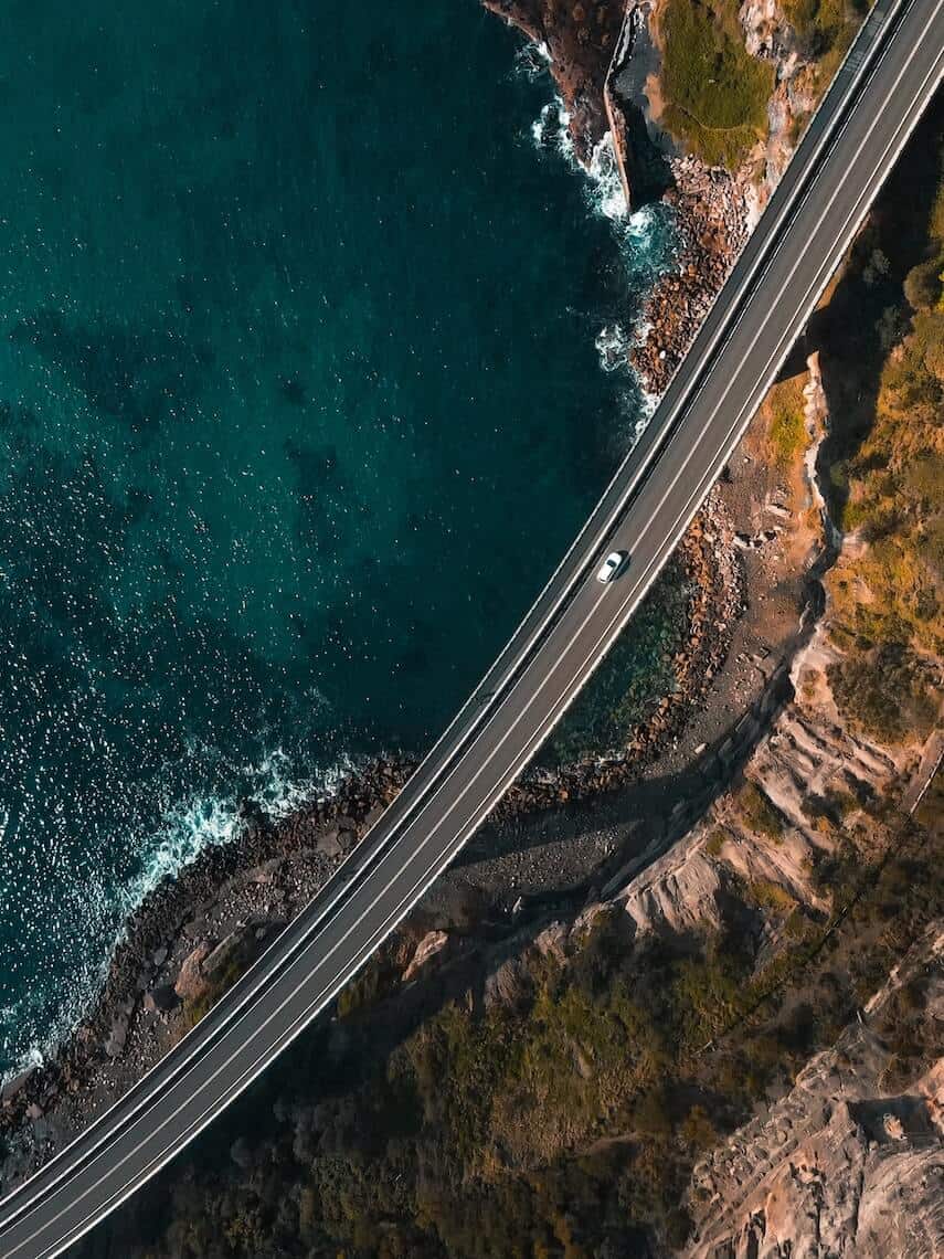 Top don shot of the Suspended Sea Cliff Bridge standing above the rocky coastline below