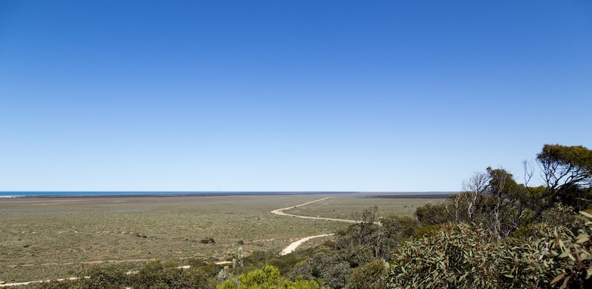 Vast expanse of the Nullabor plain with a single yellow road across it
