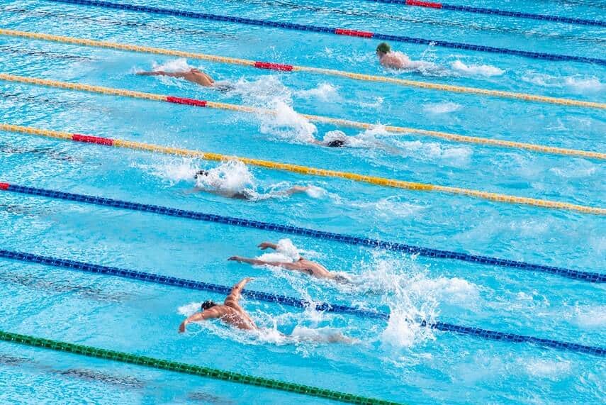 8 lanes of a swimming pool with people racing